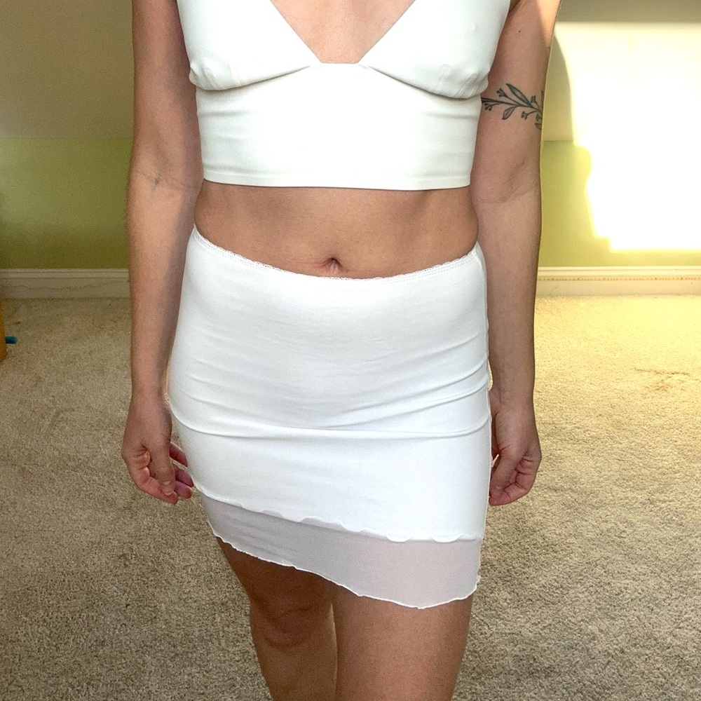 White mini skirt with mesh overlay